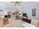 Living room with a view to dining area and kitchen, carpeted floors, and ceiling fan at 1300 Park West Blvd # 106, Mount Pleasant, SC 29466