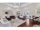 Spacious living room with elegant furnishings, chandelier lighting, and hardwood floors at 1300 Park West Blvd # 106, Mount Pleasant, SC 29466