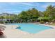 Large community pool with palm trees and lounge chairs, creating a resort-like atmosphere at 1300 Park West Blvd # 106, Mount Pleasant, SC 29466