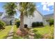 Charming backyard featuring a white storage house, stepping stone path, and lush lawn with palm tree at 132 Clear Bend Ln, Summerville, SC 29486
