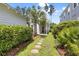 Landscaped backyard with green grass, stone pavers, and a variety of plants and trees at 132 Clear Bend Ln, Summerville, SC 29486