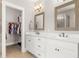 Bathroom featuring double sinks with white cabinets, marble countertops, and framed mirrors at 132 Clear Bend Ln, Summerville, SC 29486