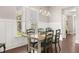 Well-lit dining area with a wooden table, six chairs, and a view through the bright windows at 132 Clear Bend Ln, Summerville, SC 29486