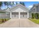 Detached two-car garage with neutral gray doors and ample driveway parking space at 132 Clear Bend Ln, Summerville, SC 29486
