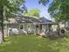 Large backyard with a deck, gazebo, fire pit area, and lush green lawn at 1337 Old Fort Rd, Moncks Corner, SC 29461