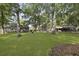 Expansive backyard with mature trees, a fire pit, and a covered parking area at 1337 Old Fort Rd, Moncks Corner, SC 29461