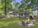 Spacious backyard with a fire pit area, wooden deck, and gazebo, ideal for outdoor enjoyment at 1337 Old Fort Rd, Moncks Corner, SC 29461