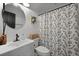 Well-lit bathroom featuring a modern vanity, round mirror, and shower with a floral curtain at 1337 Old Fort Rd, Moncks Corner, SC 29461