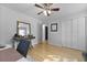 Bright bedroom featuring hardwood floors and a ceiling fan with overhead lights at 1337 Old Fort Rd, Moncks Corner, SC 29461