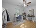 Bright bedroom features hardwood floors, a window, desk, and a ceiling fan with overhead lights at 1337 Old Fort Rd, Moncks Corner, SC 29461