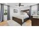 Tranquil bedroom featuring a wooden bed frame, stylish ceiling fan, and natural light from large window at 1337 Old Fort Rd, Moncks Corner, SC 29461
