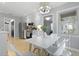 Cozy dining area features a modern chandelier, bright window, and an adjacent kitchen with stainless steel appliances at 1337 Old Fort Rd, Moncks Corner, SC 29461
