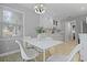 Bright dining area with a white table, modern lighting, and natural light at 1337 Old Fort Rd, Moncks Corner, SC 29461
