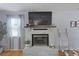 Cozy living room fireplace with a mounted TV and decorative accents at 1337 Old Fort Rd, Moncks Corner, SC 29461