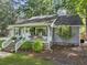 View of a quaint single-story home with a welcoming front porch, brick steps, and a well-maintained lawn at 1337 Old Fort Rd, Moncks Corner, SC 29461