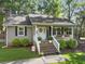 Charming home featuring a welcoming front porch, brick stairs, and beautifully landscaped front yard with mature trees at 1337 Old Fort Rd, Moncks Corner, SC 29461