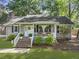 Charming single-story home with inviting front porch, brick stairs, lush landscaping, and mature trees at 1337 Old Fort Rd, Moncks Corner, SC 29461