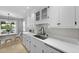 Bright, updated kitchen with white cabinets, subway tile backsplash, stainless steel sink, and eat-in dining area at 1337 Old Fort Rd, Moncks Corner, SC 29461