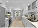 Open kitchen view, featuring stainless steel appliances, white cabinets, eat-in table, and modern backsplash at 1337 Old Fort Rd, Moncks Corner, SC 29461