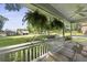 Inviting porch featuring hanging ferns and flower boxes, offering a serene view of the lush front yard and neighborhood at 1337 Old Fort Rd, Moncks Corner, SC 29461