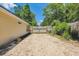 Backyard shows a long gravel drive, wood fence and lawn at 1350 Water Edge Dr, Charleston, SC 29492