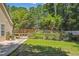 A spacious backyard features a lush lawn, mature trees, and a charming wooden fence at 1350 Water Edge Dr, Charleston, SC 29492