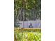 A lush green backyard with mature landscaping and a white fence is perfect for relaxing at 1350 Water Edge Dr, Charleston, SC 29492