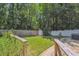 A fenced backyard features mature trees, a small shed, and a stone walking path at 1350 Water Edge Dr, Charleston, SC 29492