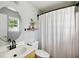 Clean bathroom featuring a shower with curtain, framed mirror and floating wood shelf at 1350 Water Edge Dr, Charleston, SC 29492