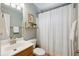 Bathroom featuring a shower with a white curtain, wooden shelf, and white vanity at 1350 Water Edge Dr, Charleston, SC 29492