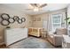 This cozy Bedroom is complete with a crib, dresser, ceiling fan, and neutral color scheme at 1350 Water Edge Dr, Charleston, SC 29492