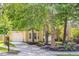 Charming home with a well-manicured lawn and mature trees shading the front yard and driveway at 1350 Water Edge Dr, Charleston, SC 29492
