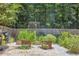 A beautiful garden features raised beds, mature plants, and stone and gravel walking paths at 1350 Water Edge Dr, Charleston, SC 29492