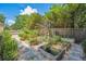 A backyard garden features raised garden beds, gravel, stone pavers, and a metal trellis at 1350 Water Edge Dr, Charleston, SC 29492