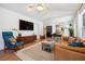 Open-concept living room featuring a leather sofa, modern decor, and wood flooring at 1350 Water Edge Dr, Charleston, SC 29492
