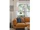 Comfortable living room with a leather sofa, window, and decorative accents at 1350 Water Edge Dr, Charleston, SC 29492