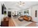 Bright living room with wood floors, a ceiling fan, and large windows offering natural light at 1350 Water Edge Dr, Charleston, SC 29492