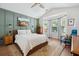 The main bedroom boasts a vaulted ceiling, wood accent wall, stylish furniture, and lots of natural light at 1350 Water Edge Dr, Charleston, SC 29492