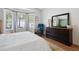 The light-filled bedroom offers soft decor, hardwood floors, a large dresser, and bay windows at 1350 Water Edge Dr, Charleston, SC 29492
