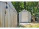 A backyard shed is accentuated by strung patio lights and mature shade trees at 1350 Water Edge Dr, Charleston, SC 29492