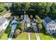 A green home located near a pond with neighboring houses in the well-maintained community at 136 Heart Pine Cir, Summerville, SC 29485