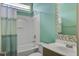 Clean bathroom with a shower-tub combo, light turquoise walls, and wood vanity at 136 Heart Pine Cir, Summerville, SC 29485