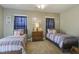 Comfortable bedroom with two twin beds, a dresser, nautical decor and carpet flooring at 136 Heart Pine Cir, Summerville, SC 29485