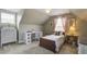 Cozy bedroom with neutral carpet, a desk, and a twin bed in a charming, well-lit space at 136 Heart Pine Cir, Summerville, SC 29485