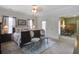 Bright bedroom featuring a large bed, neutral tones, carpet flooring and a view to another sitting room at 136 Heart Pine Cir, Summerville, SC 29485