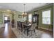 Spacious dining room with elegant chandelier, large windows, and view of living room for formal gatherings at 136 Heart Pine Cir, Summerville, SC 29485