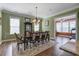Elegant dining room with a chandelier, seating for eight, and view of the exercise room at 136 Heart Pine Cir, Summerville, SC 29485