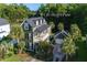 Aerial view showcases the green two-story house with a cozy porch and garage at 136 Heart Pine Cir, Summerville, SC 29485
