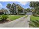 Inviting two-story home featuring a spacious driveway, lush landscaping, and a charming garage with matching paint at 136 Heart Pine Cir, Summerville, SC 29485