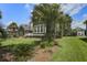 Charming home with a well-manicured lawn and mature palm trees in the front yard at 136 Heart Pine Cir, Summerville, SC 29485